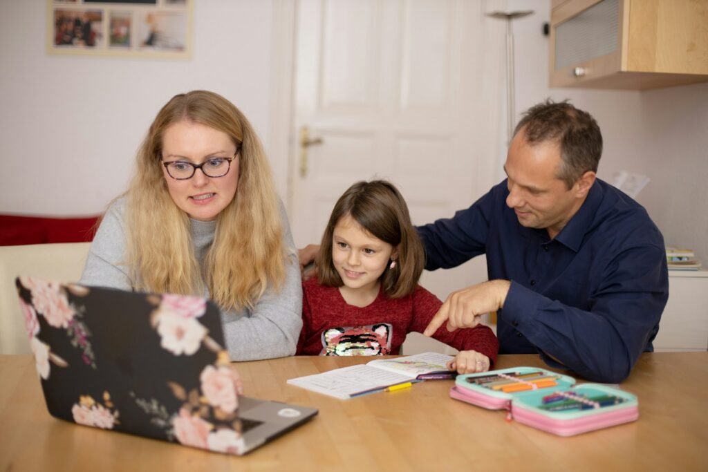 A parent and child learning together at home